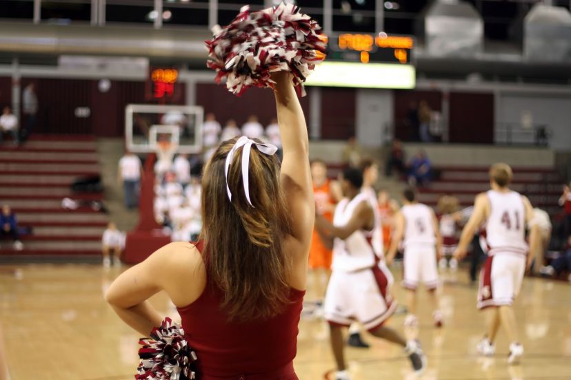 A cheerleader encourages the players.