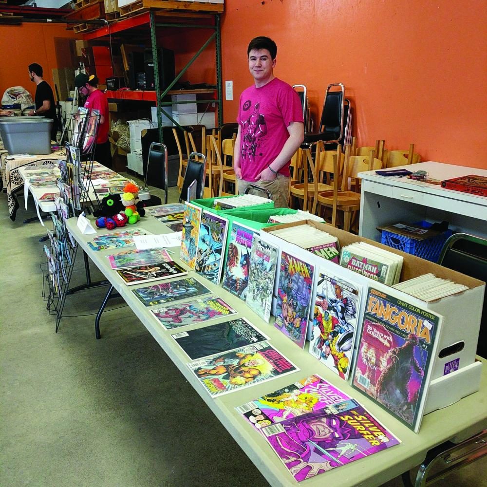 Comic enthusiast Jonah Forsey displays his collection of items for the comic book and record exchange May 13. 