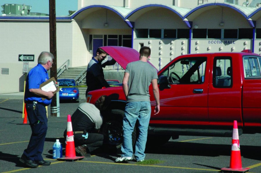 A student receives help with a vehicle at the 2017 car clinic.