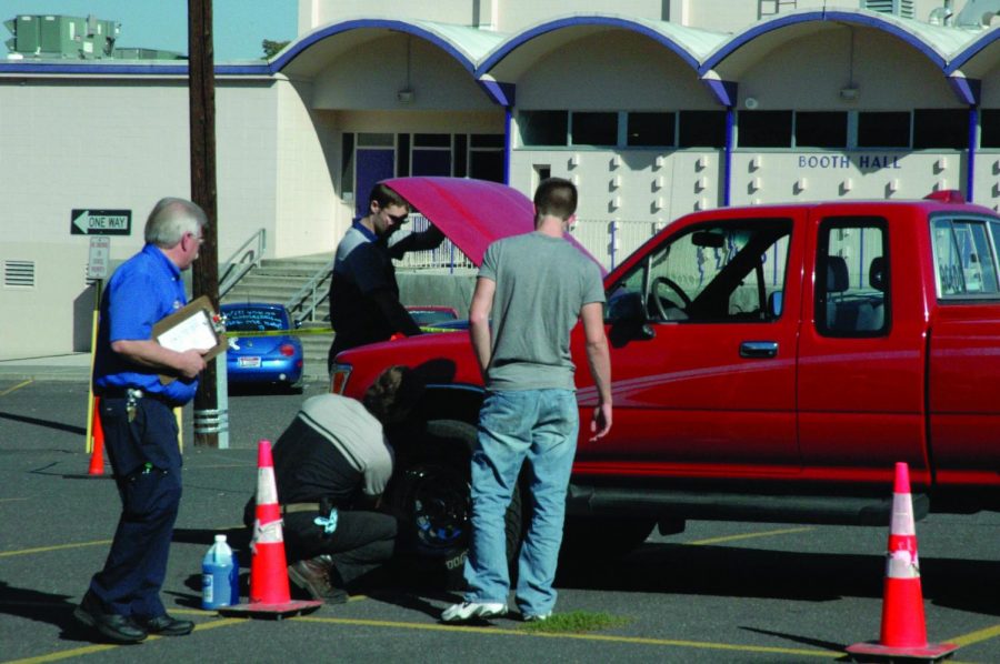 A+student+receives+help+with+a+vehicle+at+the+2017+car+clinic.