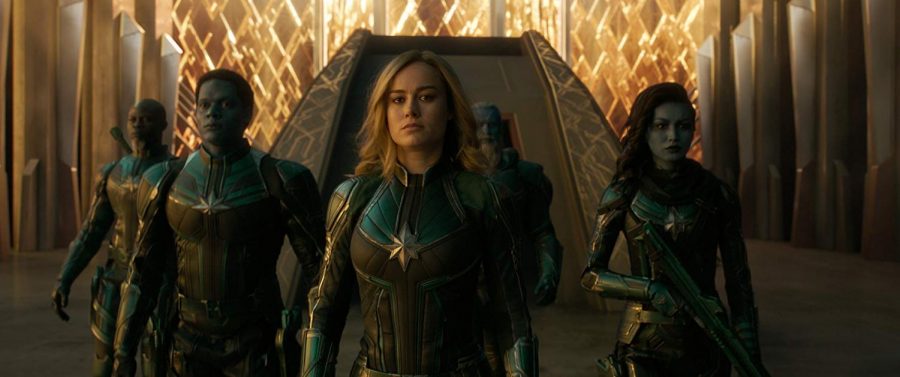 Brie Larson as Captain Marvel, stands with her assembled crew. 