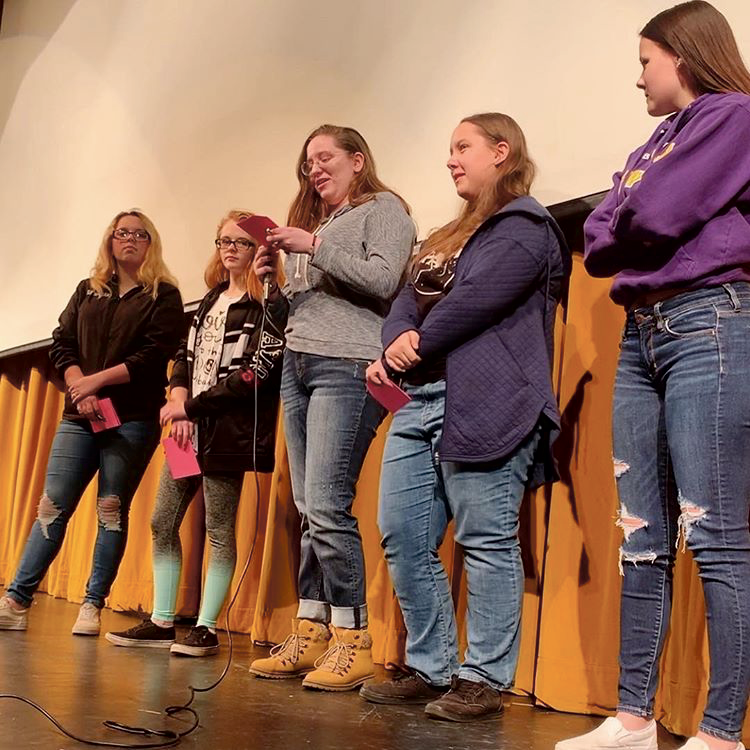 Students at the LHS Kindness Campaign assembly March 7 present their kindess cards in front of their classmates. Image courtesy of @kindcampaign on Instagram. 