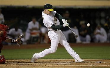 Seth Brown bats his second triple against the Los Angeles Angels at the Oakland Coliseum Sept. 3. Photo courtesy of the San Fransisco Examiner.