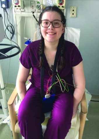 Erika Pepper sits in her hospital room after months of recovery from a lung transplant. 