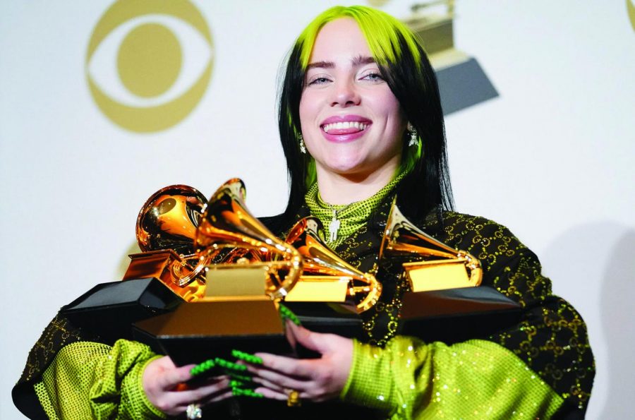 Billie Elish displays her collection of grammy trophies. Photo courtesy of Billboard.com.