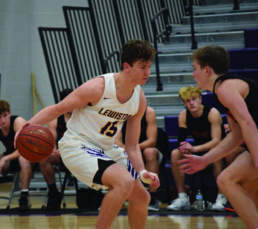 Senior Kash Lang attempts to maintain control of the ball as an opposing player approaches. Photo courtesy of Mindy Pals.