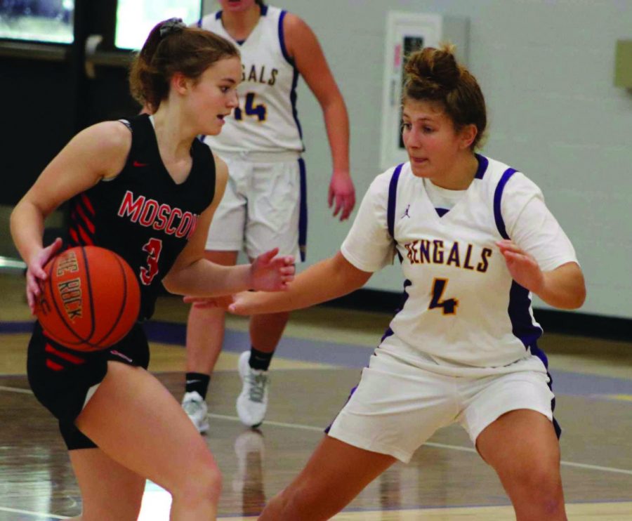 Senior Emma Hill guards a Moscow player as the opponent dribbles down the court. Photo courtesy of Mindy Pals. 
