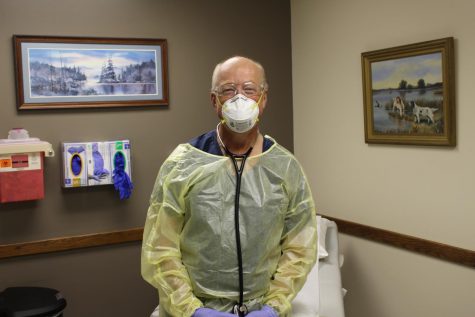 Greggain wears PPE during a COVID clinic.