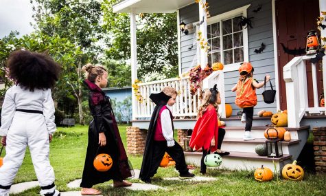 Children stand in line anticipating candy from trick-or-treating. Image courtesy of nypost.com.