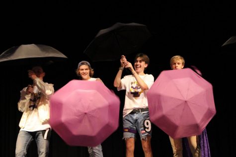 Competitors swing umbrellas during introduction dance.