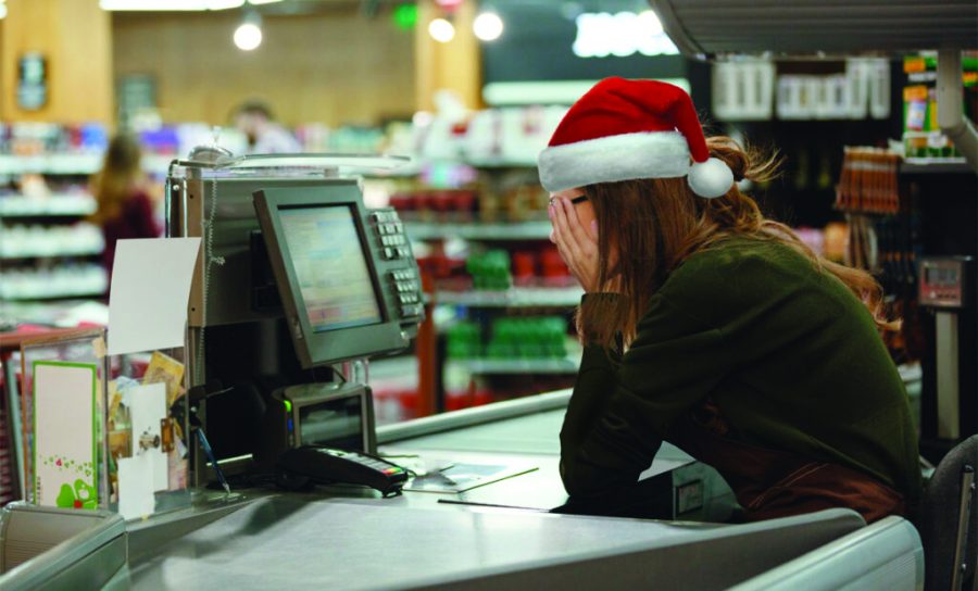 Retail worker groans in agony as “Wonderful Christmas Time” by Paul McCartney plays for the seventh time since her shift started. Photo courtesy of chaser.com. 
