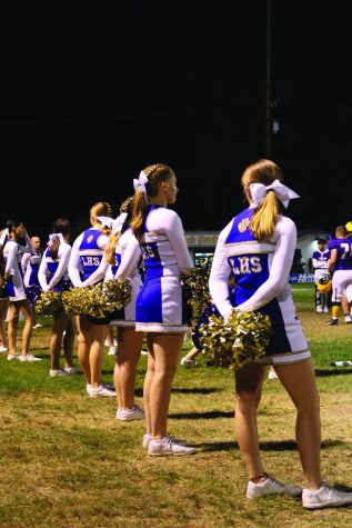 Cheerleaders support a varsity football game in the 2021-2022 school year.