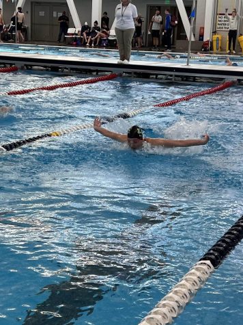 Grace Qualman, a senior and captain of the LHS swim team, flies through the water during a meet last season.