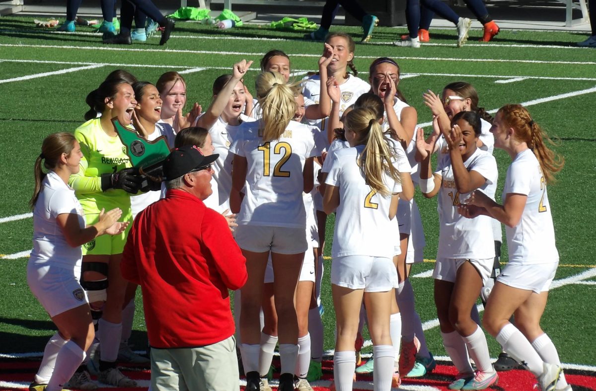 The Lewiston girls soccer team celebrates after winning third place at state with the trophy. Photo by Brooke Forth 