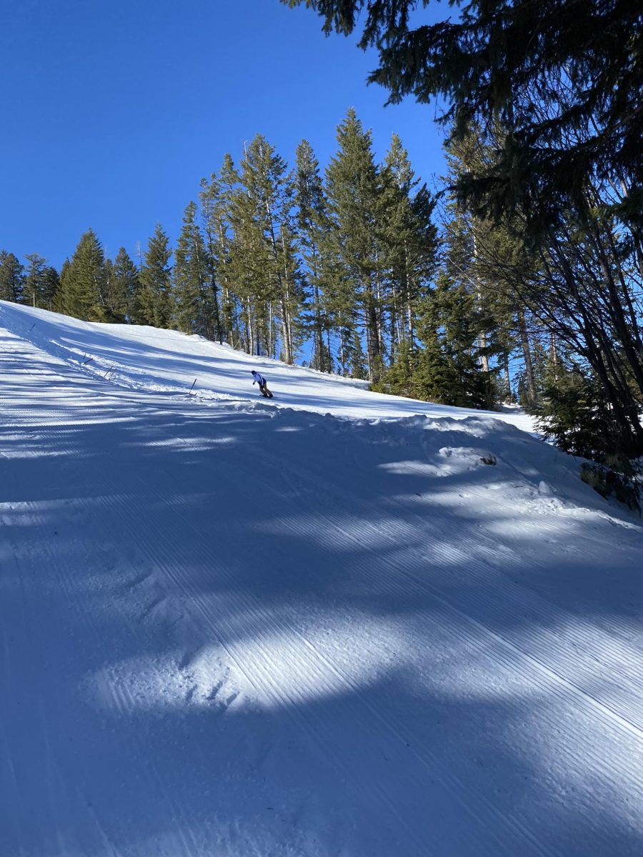 Snowboarder boards down "Jump Hill" at Snowhaven