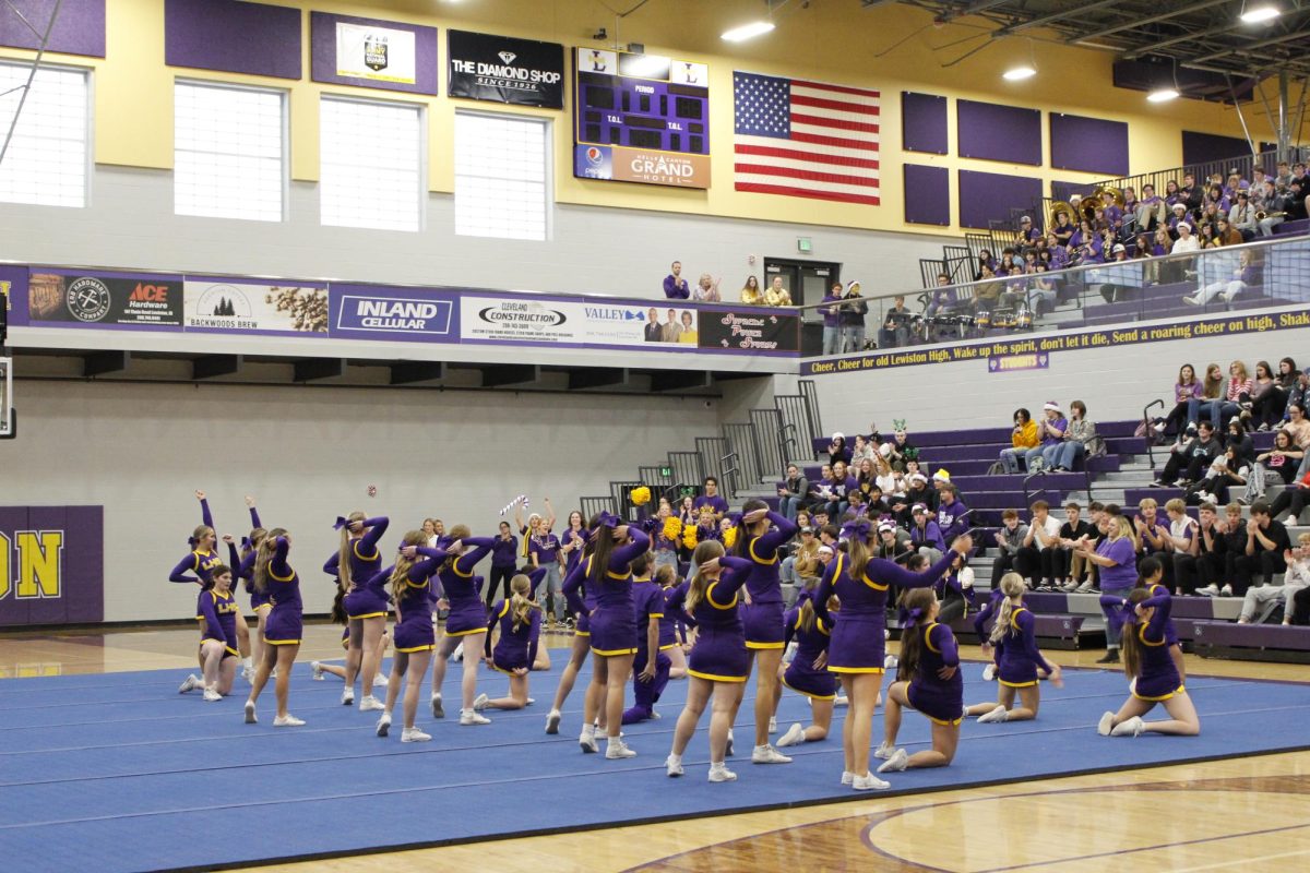 Cheerleaders make waves in the crowd at GOLDEN THRONE Assembly 2024 as they do one of their routines for the crowd of students 12/13/2024