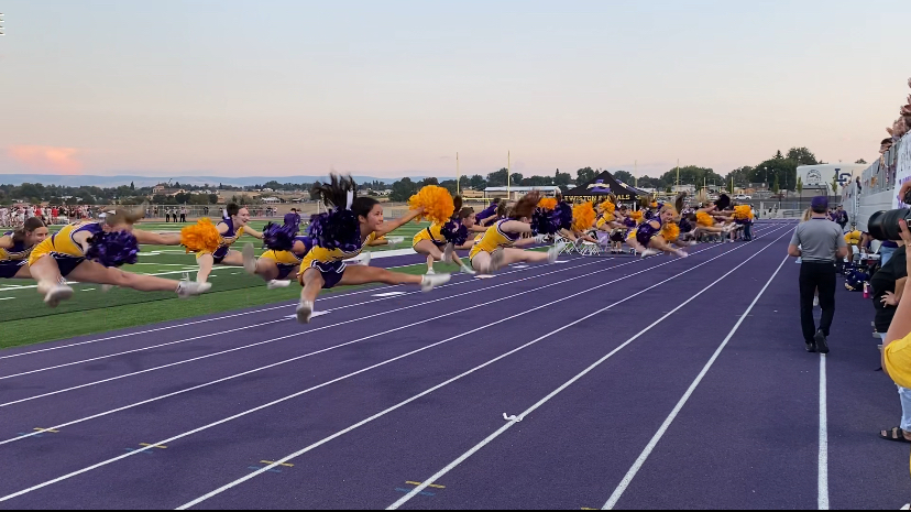 LHS Cheerleaders stunt during the Battle of the Bridges on Sept. 12