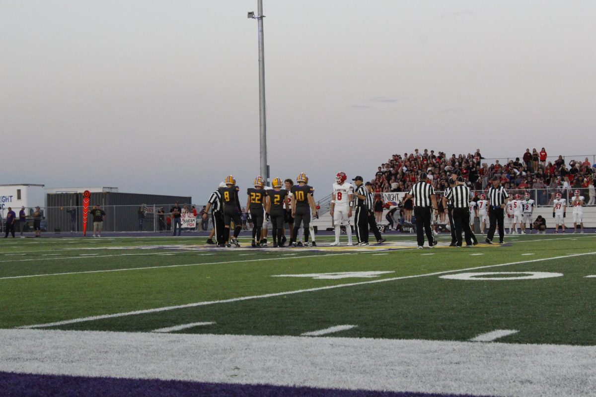 LHS Bengals face off against CHS Bantams on the logo for a coin flip