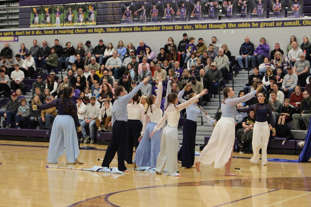 Winter Guard performs at a basketball game.
